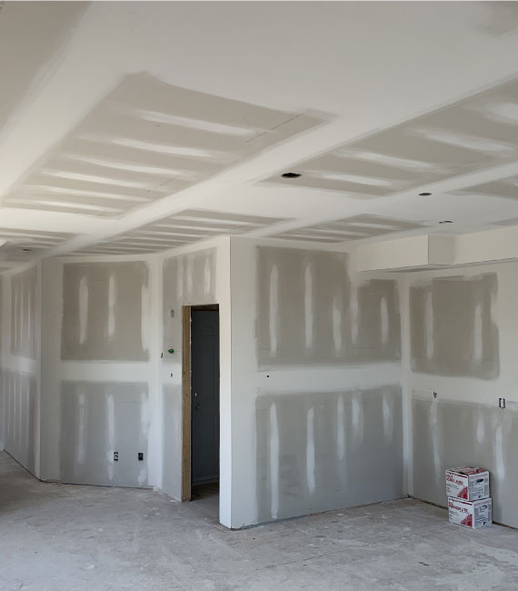Freshly taped and finished drywall ceiling and walls in a custom-built room, Clarence-Rockland